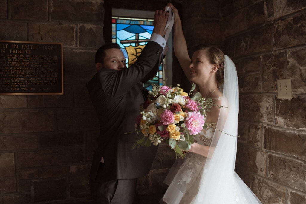 Killarney Mountain Lodge Wedding couple ringing the church bell. 