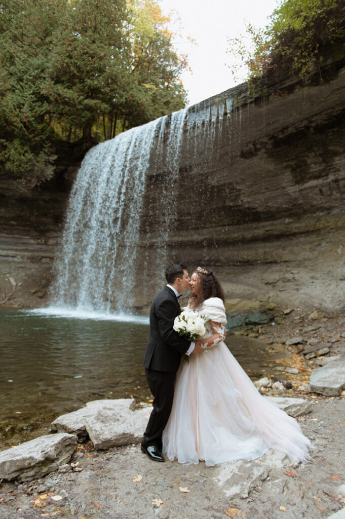 Manitoulin Island wedding photo of the happy couple in front of bridal veil falls. 