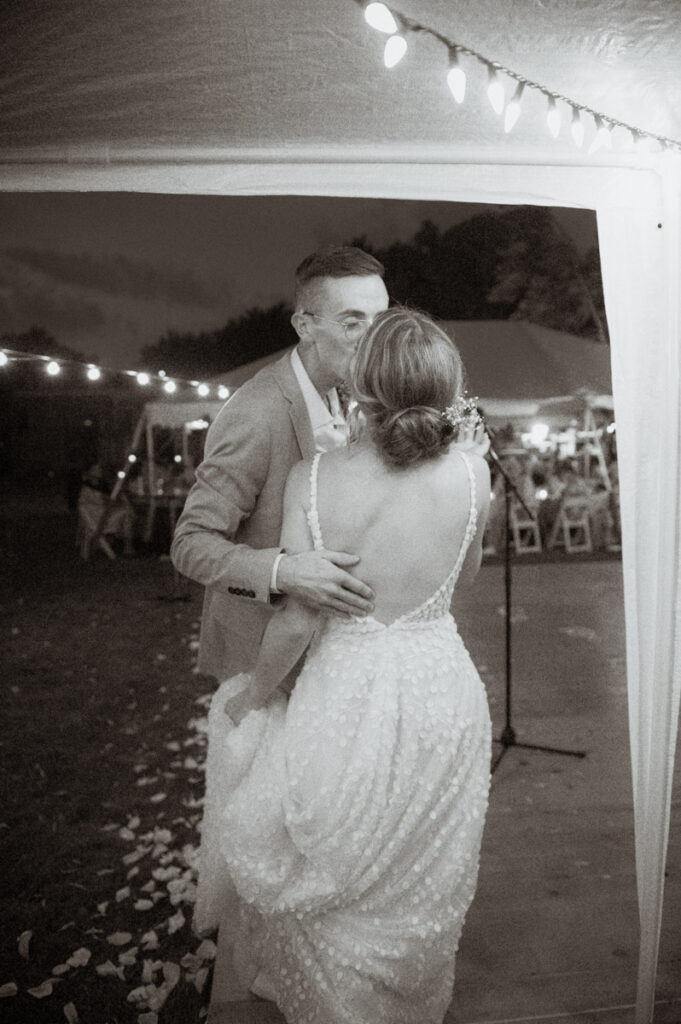 Sudbury backyard wedding couple kissing under twinkle lights. 