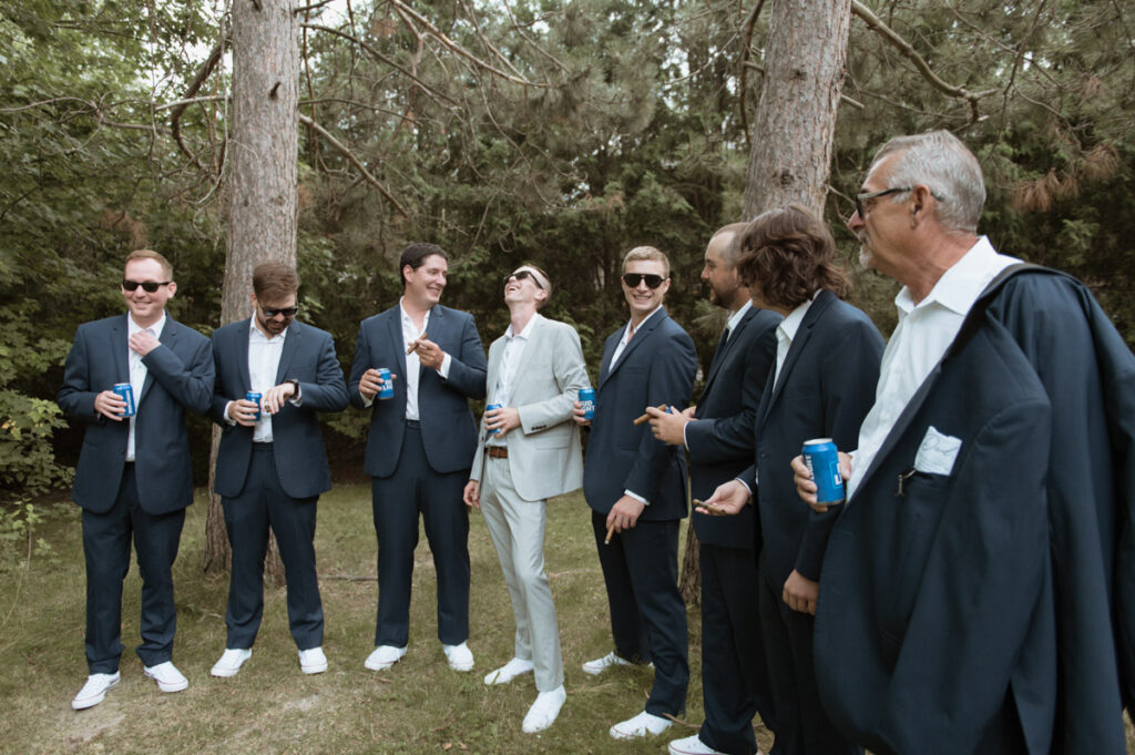 Sudbury backyard wedding groom laughing with friends. 
