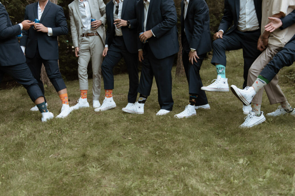 Sudbury Backyard Wedding groom and guys showing off funky socks. 