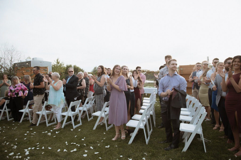 Sudbury backyard wedding guest clapping after ceremony. 
