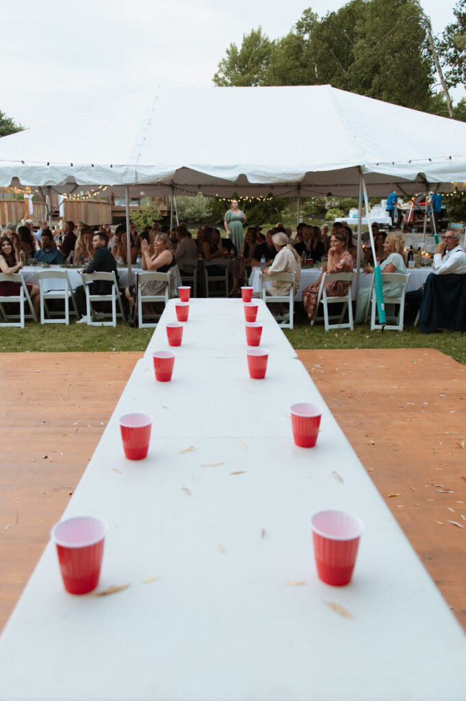Sudbury backyard wedding flip cup table with cups ready to play a game. 