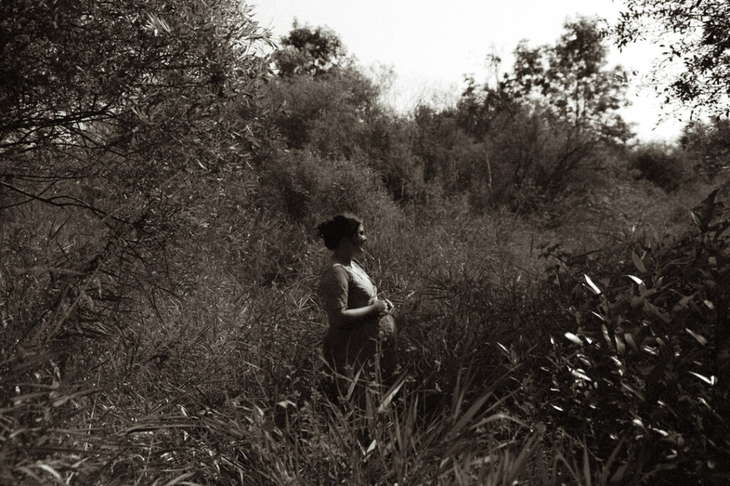 pregnant female couple in a field by an Ontario Documentary Photographer 