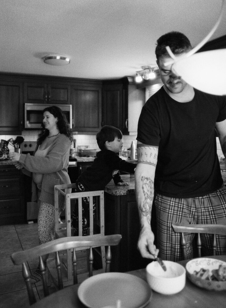 Family in kitchen preparing meal documented by a Sudbury Family Photographer. 