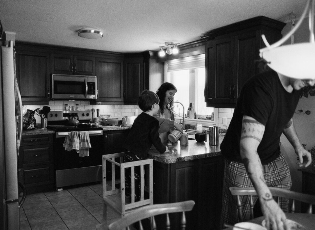 Family in kitchen preparing meal documented by a Sudbury Family Photographer. 
