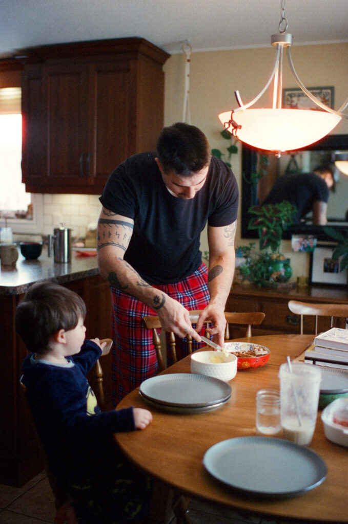 Family in kitchen preparing meal documented by a Sudbury Family Photographer. 