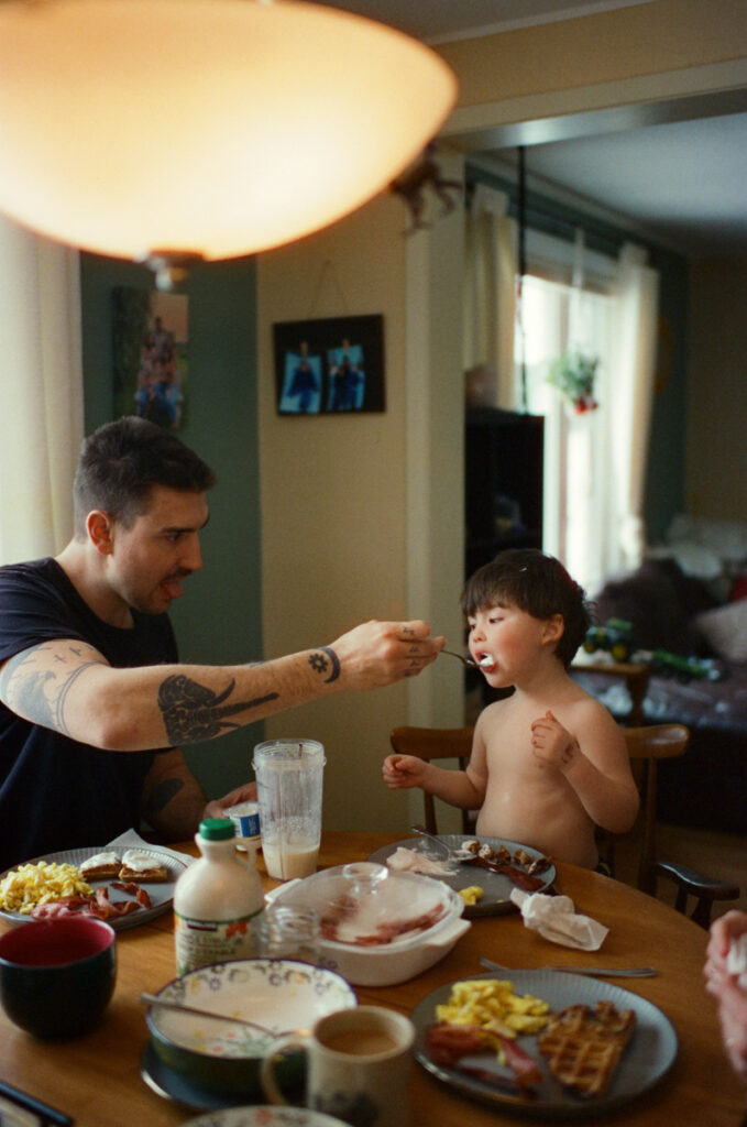 Documentary-style image by Sudbury family photographer showing a candid family moment at home