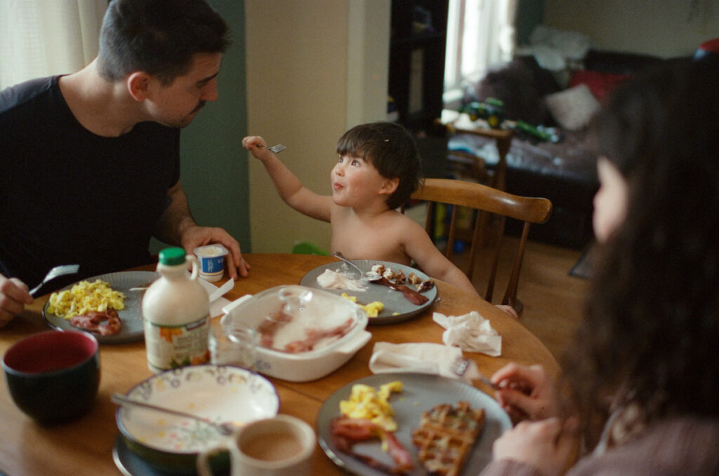 Documentary-style image by Sudbury family photographer showing a candid family moment at home