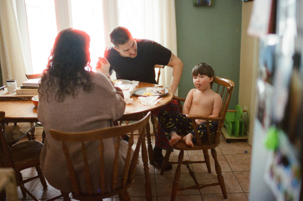 Documentary-style image by Sudbury family photographer showing a candid family moment at home
